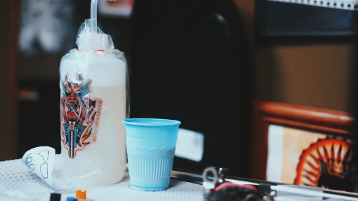 A water bottle used for cleaning tattoo ink.