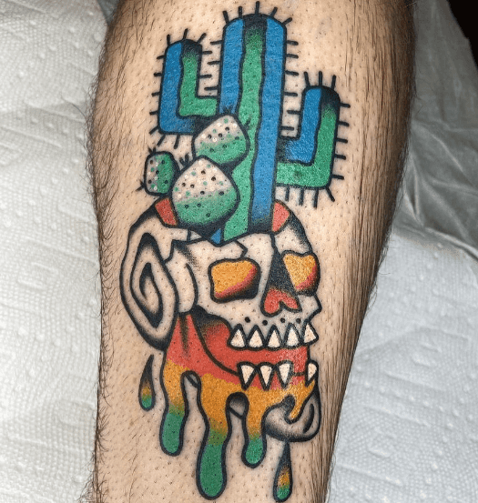 A tattoo of a cactus growing out of a skull.