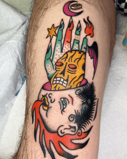 A tattoo of a monster hand coming out of a baby's head.