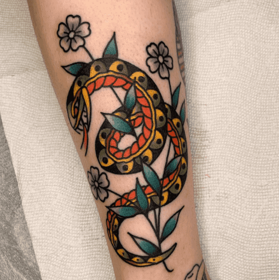 A tattoo of a snake wrapped around a flower.