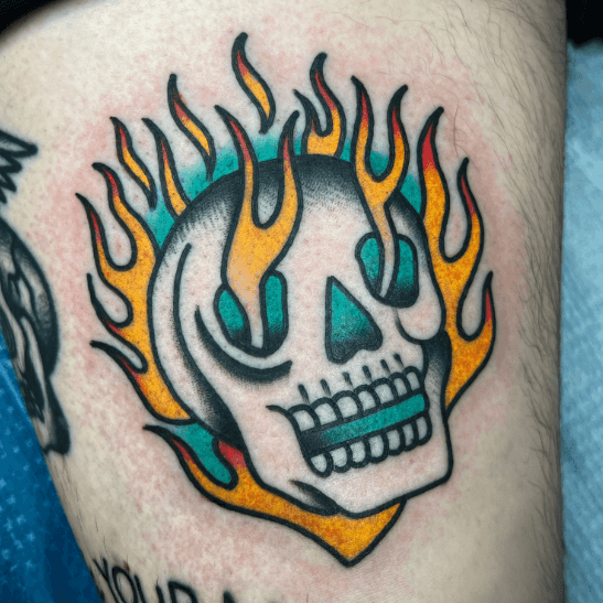 A tattoo of flaming skull.