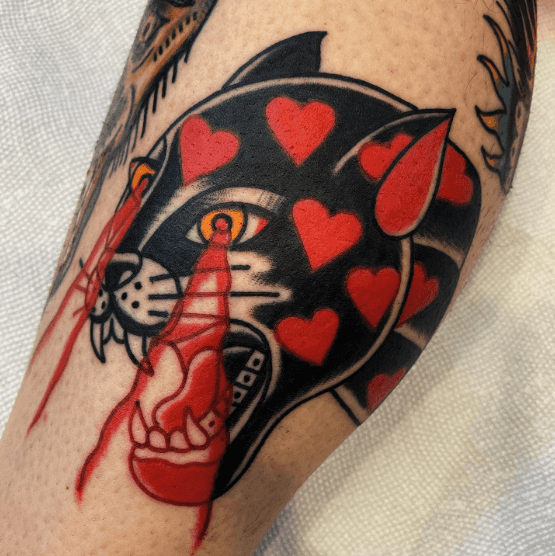 A tattoo of a panther's head shooting lasers from its eyes.