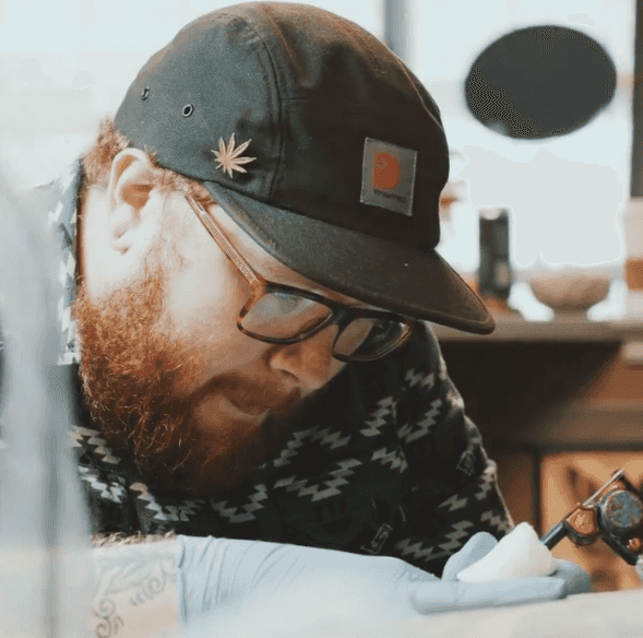 Artist sketching a tattoo design.